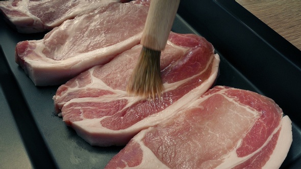 Brushing Oil On Pork Chops For Cooking