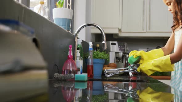 Girl washing utensils in the kitchen 4K 4k