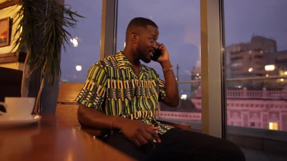 AfricanAmerican Man Talking By Smartphone