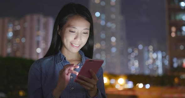 Woman use of smart phone at night