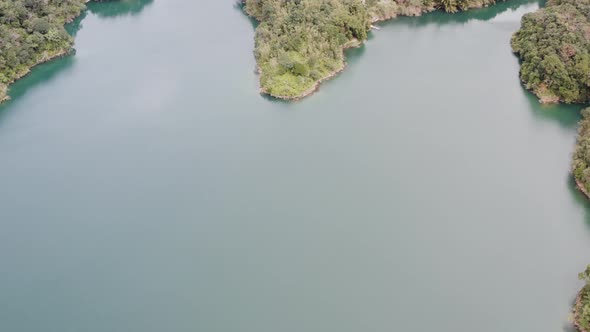 Ascending tilting camera view of Spectacular View of Feitsui Reservoir, Emerald lake, Thousand Islan