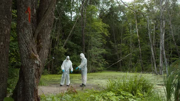 People Wearing Protective White Suits Working at Accident Crime Place and Talking