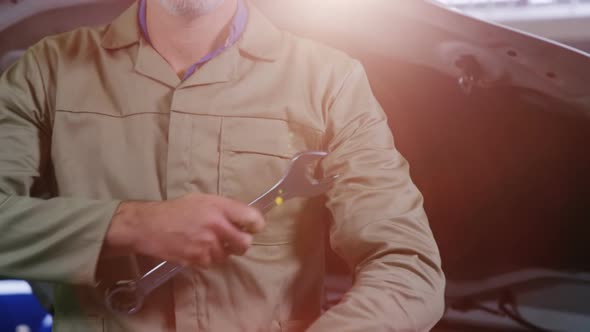 Mechanic standing with arms crossed