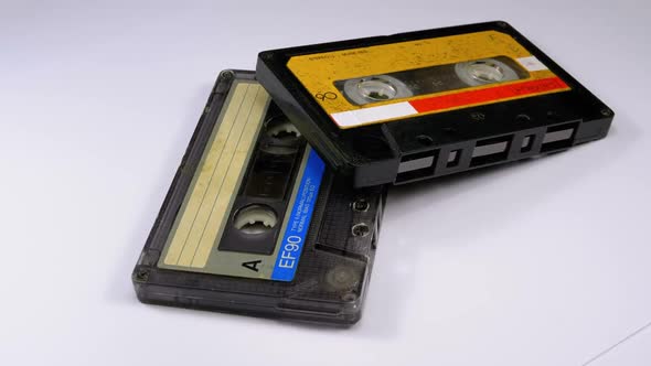 Two Vintage Audio Cassette Rotates on White Background