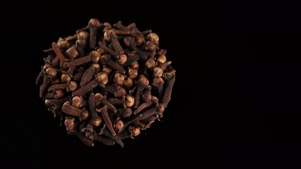 Whole Cloves on black background, rotate. Spice cloves