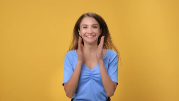 Portrait Overjoyed Blonde Female Jumping Clapping Hands Rejoicing Good News Posing Isolated Orange