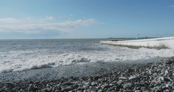 Sea Surf on Rocky Beach. Tranquil Natural Background at Sunny Day. Black Sea, Sochi, Russia.