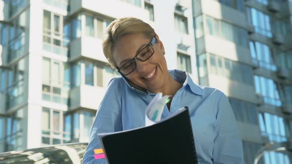 Smiling Business Lady Talking on Smartphone Outdoors, Rejoicing Successful Deal