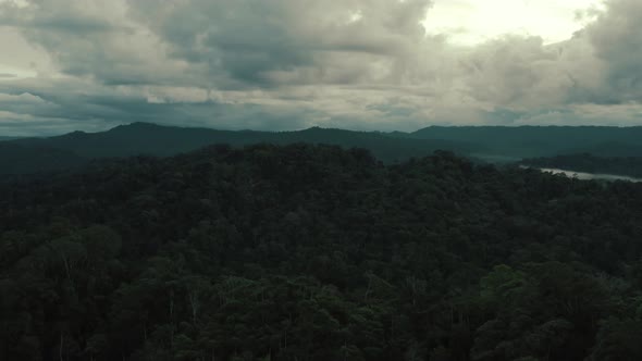 A beautiful dark cloudscape is hanging over a tropical forest after a rainy day