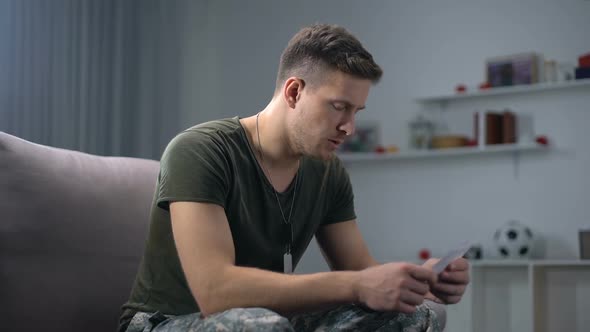 Disappointed Male Soldier Tearing Family Photo Break-Up and Relationship Problem