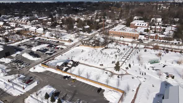 People having fun in ice rink at The Gardens at Pillar and Post, drone shot passing over