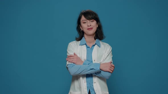 Portrait of Woman Scientist Crossing Arms Over Blue Background