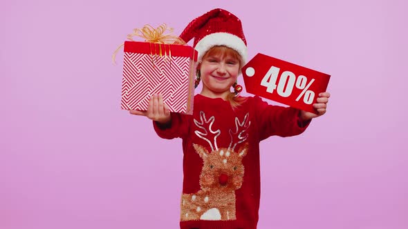 Toddler Girl in Christmas Hat Showing Gift Box and 40 Percent Discount Inscriptions Banner Note Text