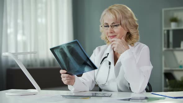 Experienced Female Radiologist Studying X-Ray Picture Qualified Diagnostics