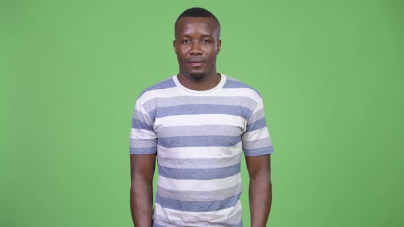 Young African Man Against Green Background