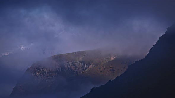 Timelapse of clouds cover mountain peaks