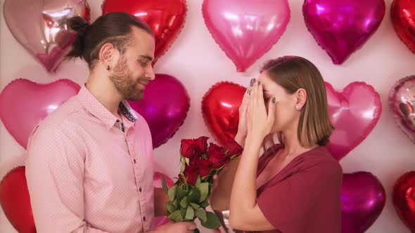 Closeup Romantic Woman Smelling Bouquet of Red Flowers Received From Boyfriend