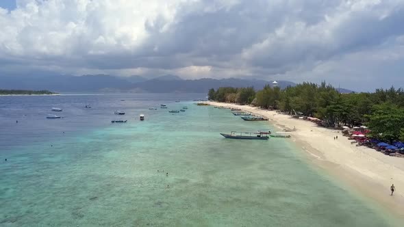 big sky Incredibly clouds.Spectacular aerial view flight fly backwards drone footage of Gili Trawan