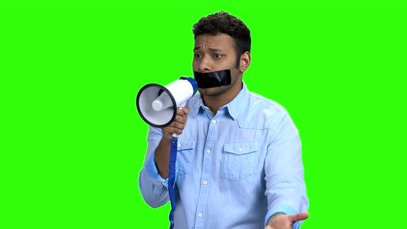 Expressive Man with Taped Mouth Trying To Speak