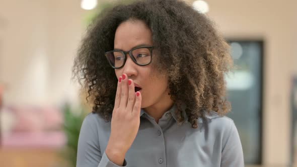 Portrait of Sleepy African Businesswoman Yawning