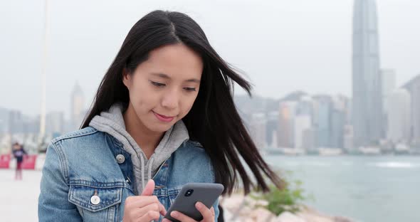 Young woman use of mobile phone at outdoor park