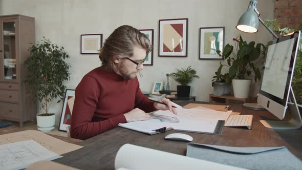 Male Architect With Sketches Posing For Camera