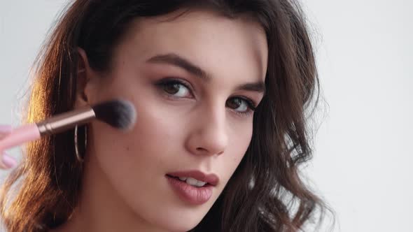 Facial Makeup Woman Applying Blush on Face Skin