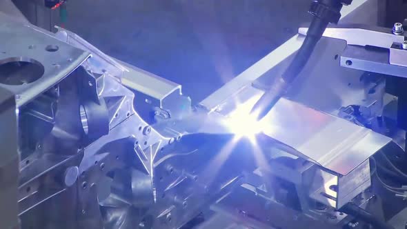 Robots are welding in automobile factory. assemble a car in fast motion.