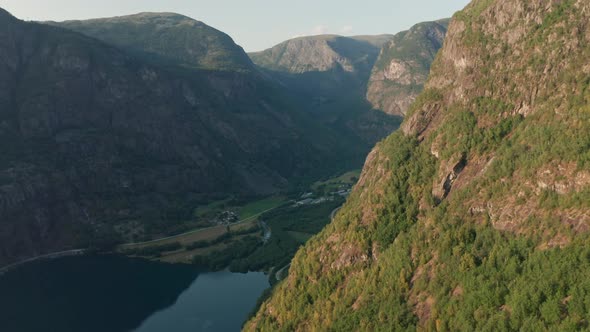 Drone Over Mountains To River In Valley Below