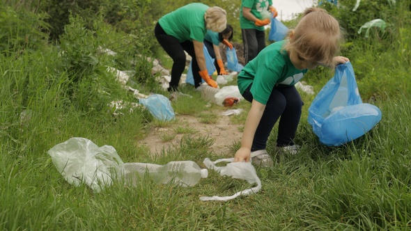 Volunteer Team Cleaning Up Dirty Park From Plastic Bags, Bottles. Reduce Trash Cellophane Pollution