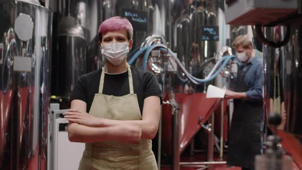 Portrait Of Female Brewery Worker In Mask