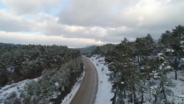Asphalt road, snowy land.