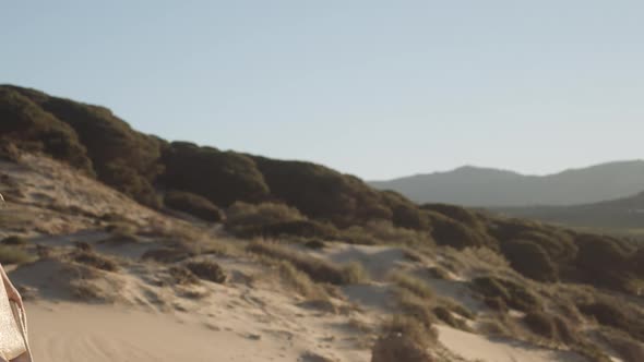 Beautiful Woman In Gold On Beach