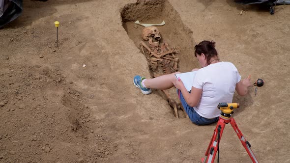 Young Archeologist Works on an Archaeological Site at Morning Sun Rays at Summer Heat