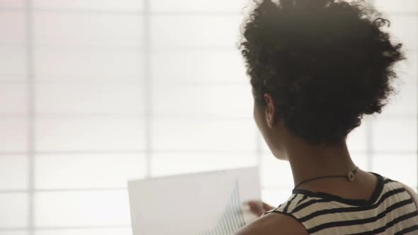 Businesswoman examining bar graph