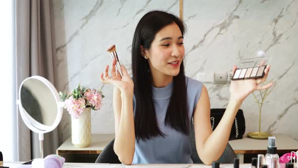 Portrait of young asian Fashion blogger woman review product,