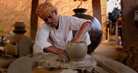 Indian Potter at Work: Throwing the Potter's Wheel and Shaping Ceramic Vessel and Clay Ware: Pot