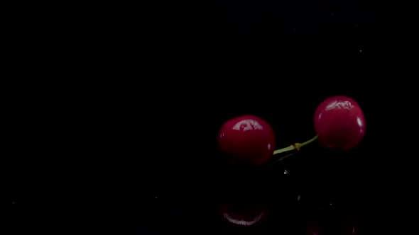 Cherry Slow Motion Closeup Falling in Water with Splash Droplets