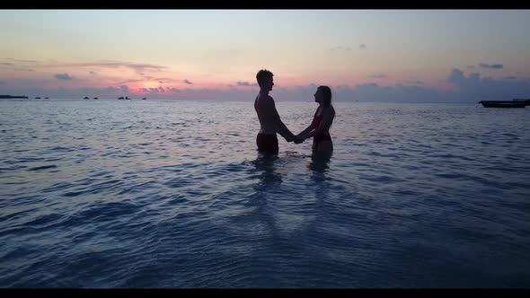 Young couple tan on relaxing seashore beach lifestyle by turquoise sea with white sand background of