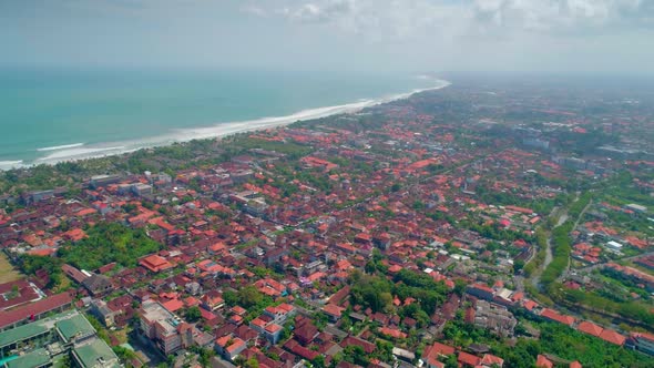 Aerial View The City On The Shore Of The Indian Ocean. The Island Of Bali.