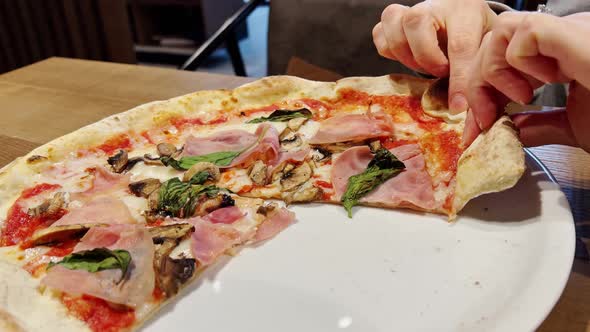 Female Hands Taking Slices of Pizza