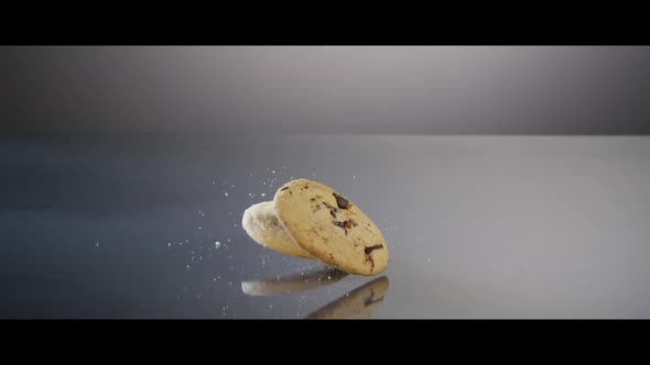 Falling cookies from above onto a reflective surface