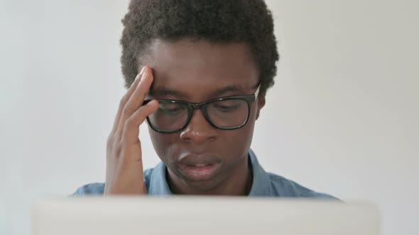 Close Up of Young African Man Having Headache While Working on Laptop