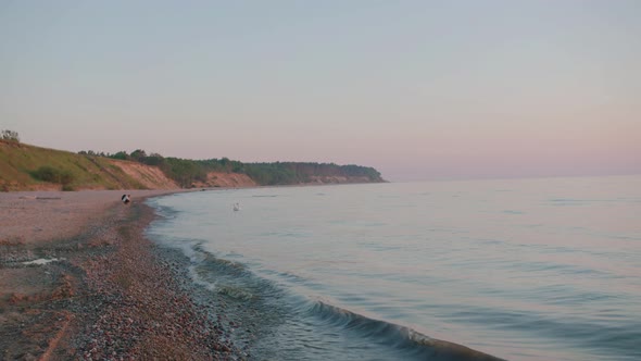 Baltic sea at sunset,small waves hitting stones