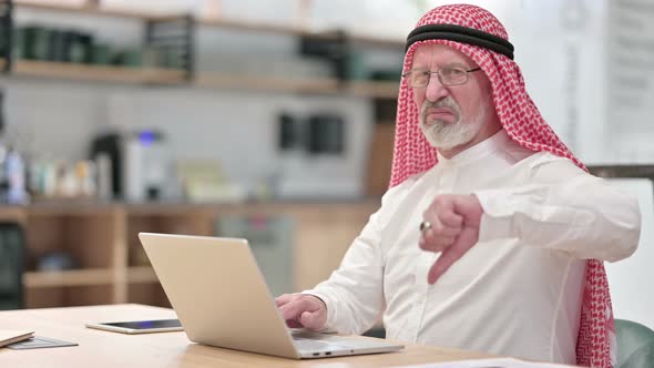 Senior Old Arab Businessman with Laptop Showing Thumbs Down 