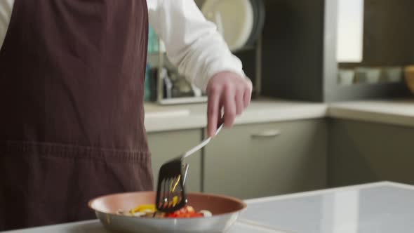 Man Blogger Shows Process of Cooking Dish with Vegetables