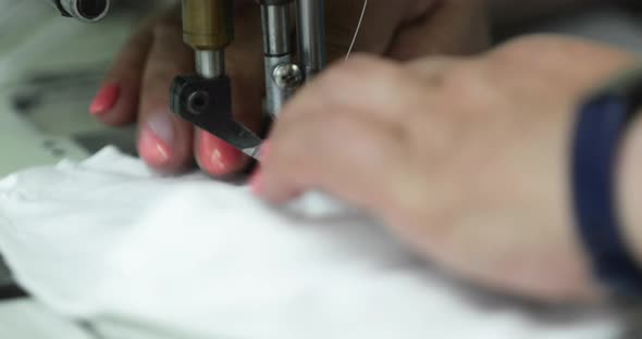 Needle Of Sewing Machine Used By A Seamstress In Sewing White Fabric Mask In A Garment Industry - ex