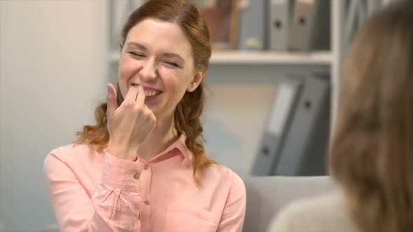 Lady Showing Her Friend Is Funny in Sign Language Conversation for Deaf Dialogue