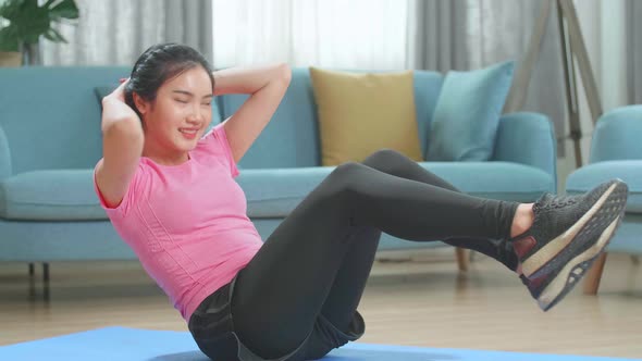 Strong And Fit Beautiful Girl Doing Crisscross Crunch Workout In Her Living Room Home