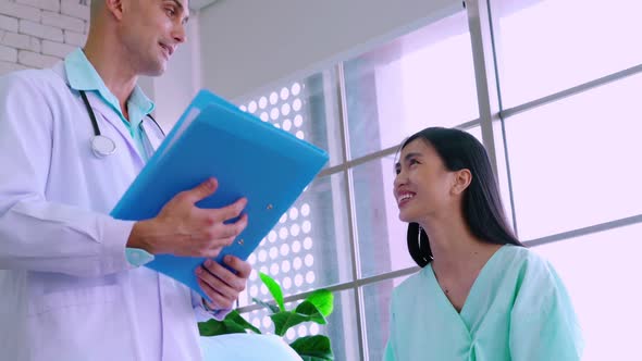 Doctor in Professional Uniform Examining Patient at Hospital